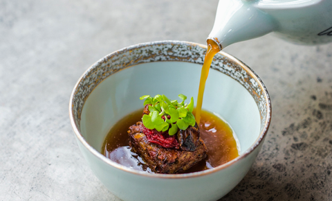 Sop buntut with oxtail and dashi broth, charred onion and tomato raisin
