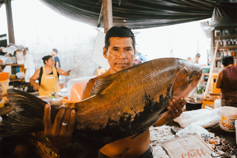 fisherman holding paiche