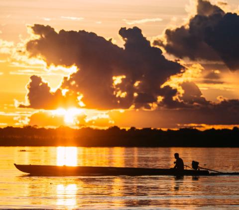 Villager with his boat on the river